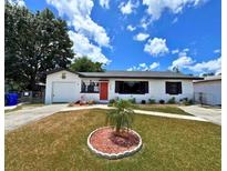 Charming single story home with a well maintained lawn and landscaping at 1442 Gilmore Ave, Lakeland, FL 33805