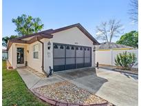 Charming single Gathering home featuring a well-maintained lawn and driveway at 1822 Nicaragua Way, Winter Haven, FL 33881