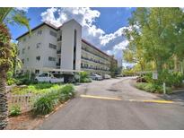 Spacious condo complex with multi-story levels, ample parking, and lush landscaping providing a serene atmosphere at 200 El Camino Dr # 206, Winter Haven, FL 33884