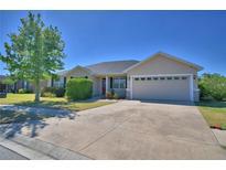 Lovely single-story home with a well-manicured lawn, neutral stucco exterior, and two-car garage at 2110 Saddlewood Dr, Bartow, FL 33830