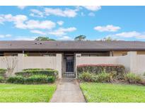 Charming condo featuring a private courtyard with lush landscaping and a secure gated entrance at 2254 Firestone Pl # 2254, Winter Haven, FL 33884