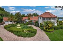 Stunning exterior of a home featuring lush landscaping, a charming fountain, and a paver driveway at 2300 N Scenic Hwy # 61, Lake Wales, FL 33898
