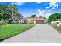 Charming single-story home with a well-manicured lawn and a spacious driveway at 247 Valentino Ct, Davenport, FL 33837