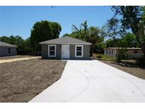 Charming home featuring a new concrete driveway, modern paint, and meticulously maintained landscaping at 3438 Avenue E Nw, Winter Haven, FL 33880