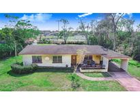 Charming single-story home featuring a well-maintained lawn and covered carport at 352 W Graham Park Dr, Haines City, FL 33844