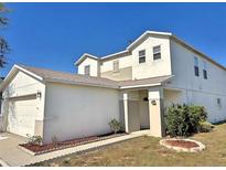 Charming two-story home featuring neutral tones and a well-manicured front yard at 356 Rona Ln, Davenport, FL 33897