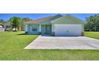 Charming one-story home with a well-manicured lawn and a spacious two-car garage at 990 Brooke Rd, Fort Meade, FL 33841