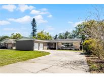 Charming single-story home with a long drive and well-maintained lawn at 136 Hampden Rd, Winter Haven, FL 33884