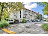 Condo building features multiple levels, balconies, and ample parking in a well-maintained community setting at 200 El Camino Dr # 202, Winter Haven, FL 33884