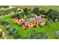 Stunning aerial view of a custom home with lush landscaping and a private pool at 2300 N Scenic Hwy # 56, Lake Wales, FL 33898