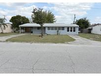 Charming single-story home with gray siding and a well-maintained front lawn at 253 Walter Ave, Frostproof, FL 33843