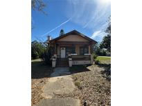 Charming bungalow with a covered front porch, steps, and a walkway leading to the house at 334 Main St, Haines City, FL 33844