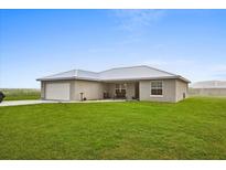 Well-maintained, single story home featuring a front-facing two car garage and covered entry way at 3608 Garrard Rd, Fort Meade, FL 33841