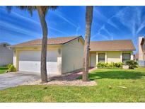 Charming one-story home with attached garage and landscaped front yard, featuring a brick walkway to the front door at 4174 Pirates Lndg, Winter Haven, FL 33884