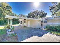 Inviting single-story home featuring a spacious carport and well-maintained landscaping at 919 Avenue S Se, Winter Haven, FL 33880