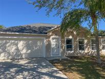 Charming single-Gathering home with a well-maintained lawn, a two-car garage, and a welcoming front entrance at 1106 Partridge Way, Kissimmee, FL 34759