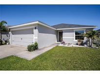 Charming single-story home featuring a well-manicured lawn and an attached two-car garage at 1108 Zion Dr, Haines City, FL 33844