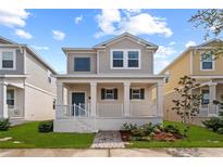 Charming two-story home with a cozy front porch and well-maintained landscaping at 1744 Cross Prairie Pkwy, Kissimmee, FL 34744