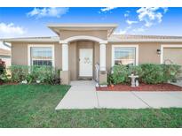 Inviting home entrance with landscaped yard and decorative details at 238 Lake Eloise Pointe Blvd, Winter Haven, FL 33880