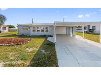 Charming single-story home with a carport and well-maintained front yard at 319 Thomas Ave, Frostproof, FL 33843