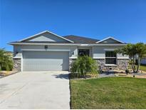 Charming single-story home with a well-manicured lawn and a two-car garage, plus stone accents at 398 Quarry Rock Cir, Kissimmee, FL 34758