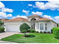 Charming single-story home with manicured lawn, brick driveway, and a two-car garage at 4088 Dunmore Dr, Lake Wales, FL 33859