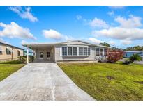 Charming single-story home with a covered carport and well-manicured lawn at 6433 Jacaranda Ne Ave, Winter Haven, FL 33881