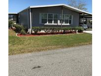 Charming single-story home featuring well-maintained landscaping and covered parking at 6515 Raintree Ne Ln, Winter Haven, FL 33881