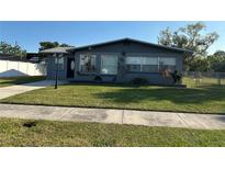 Charming single-story home featuring a well-manicured lawn, dark brick exterior, and a cozy, inviting curb appeal at 707 Great Barford St, Auburndale, FL 33823