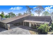 Unique home featuring a carport with stone columns and a spacious driveway at 2750 W Lake Hamilton Dr, Winter Haven, FL 33881