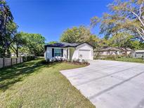 Charming single-story home featuring fresh landscaping and a long concrete driveway at 3023 Thornhill Rd, Winter Haven, FL 33880