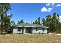 Charming single-story home with a well-manicured lawn and a classic design at 3120 Oleander Dr, Indian Lake Estates, FL 33855