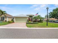 Charming single-story home featuring a well-manicured lawn and brick driveway at 3912 Baldwin Ln, Winter Haven, FL 33884