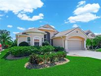 Charming single-Gathering home featuring lush landscaping, a two-car garage, and a well-manicured lawn at 4313 Heath Land Ln, Lake Wales, FL 33859