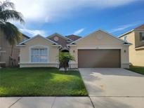 Charming single-story home with a well-maintained lawn and two-car garage at 4610 Yellow Bay Dr, Kissimmee, FL 34758