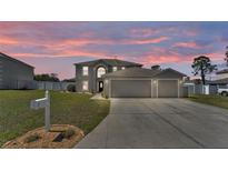 Charming two-story home with a spacious three car garage, and a well-manicured lawn at 5106 Spanish Oaks Dr, Lakeland, FL 33805