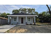 Charming single-story home featuring neutral paint, black shingle roof and decorative stone accents at 615 Avenue S Ne, Winter Haven, FL 33881