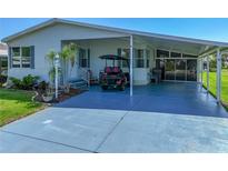 Charming home featuring a covered carport, an enclosed lanai and well-maintained landscaping at 6603 Scenic Point Se Dr, Winter Haven, FL 33884