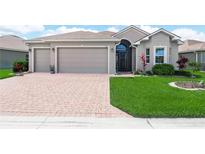 Charming single-story home featuring a well-manicured lawn and a spacious three-car garage at 1057 Sawgrass Dr, Winter Haven, FL 33884