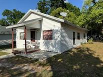 Charming single-story home featuring a covered porch and a well-maintained yard at 1109 Neville Ave, Lakeland, FL 33805