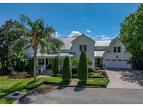 Beautiful two-story home with lush landscaping, a manicured lawn, and charming front porch at 125 E Graham Park Dr, Haines City, FL 33844