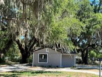 Charming renovated home with a gray exterior and mature trees at 180 Old Connersville Rd, Bartow, FL 33830