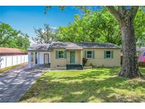 Charming single-story home featuring a well-maintained lawn and a covered parking area at 320 S Elm Rd, Lakeland, FL 33801