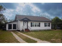 Charming one-story home featuring a well-maintained lawn and a classic white exterior, creating a welcoming curb appeal at 420 N 5Th St, Lake Wales, FL 33853