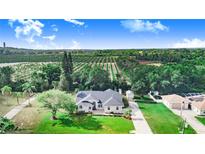 Landscaped home featuring detached garage, long driveway and sprawling greenery in the rear at 508 Starr Ridge Dr, Lake Wales, FL 33898
