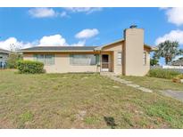 Charming single-story home featuring a unique chimney and cozy curb appeal in a residential neighborhood at 1032 Tower Blvd, Lake Wales, FL 33853