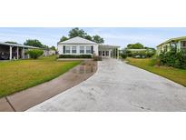 Charming single-story home featuring a covered carport and a well-maintained front yard and walkway at 1610 Reynolds Rd # 72, Lakeland, FL 33801