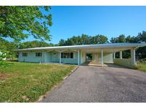 Charming single-story home featuring a covered carport and well-maintained front yard at 219 Willow St, Lake Wales, FL 33859