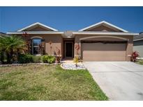 Charming one-story home boasts a well-manicured lawn and colorful landscaping at 249 Haines Blvd, Winter Haven, FL 33881