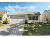 Charming single-story home featuring a well-maintained lawn and a one-car garage at 259 Mariposa, Winter Haven, FL 33884